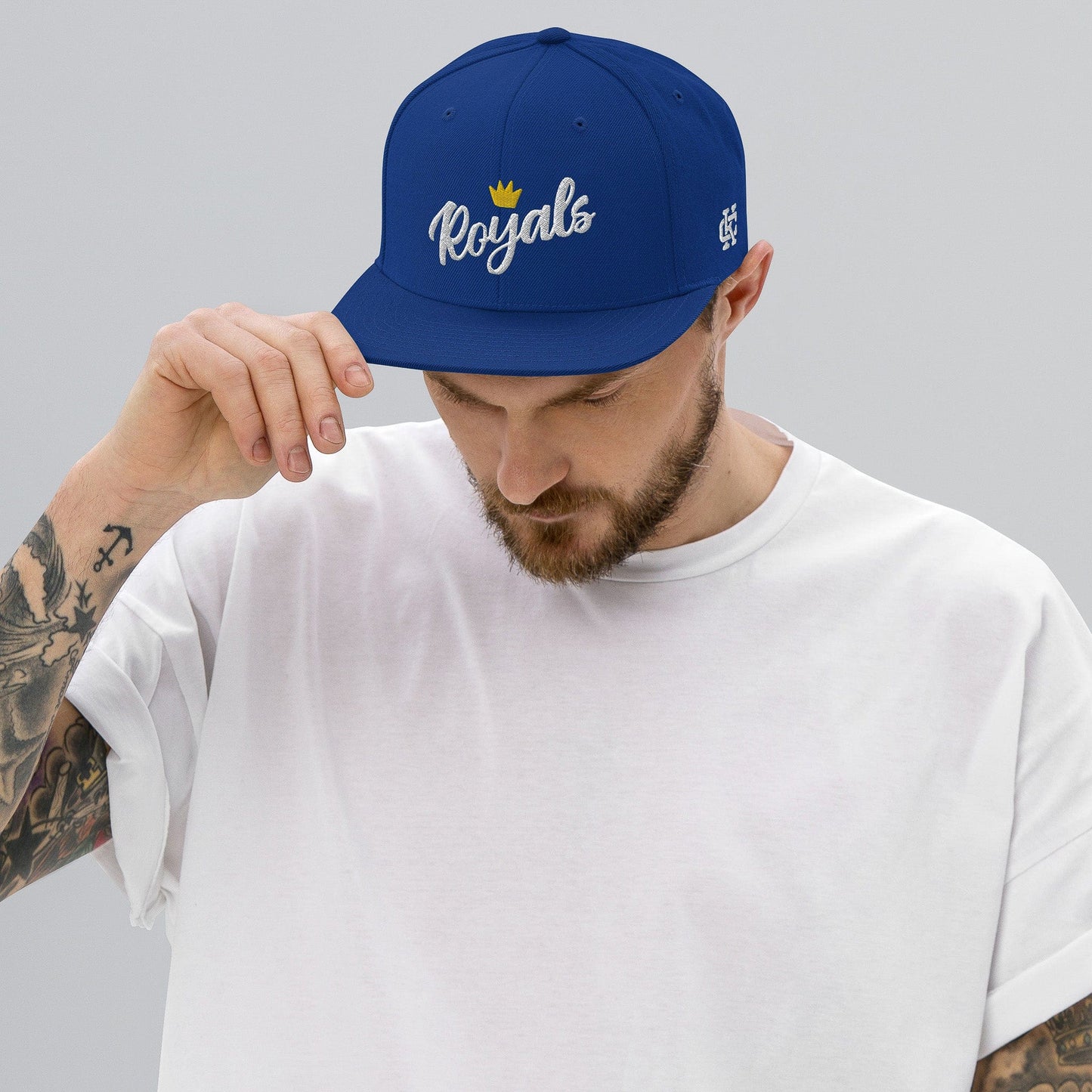 KC Swag Kansas City Royals Blue Flower Crown Flat Snapback Hat worn by male model