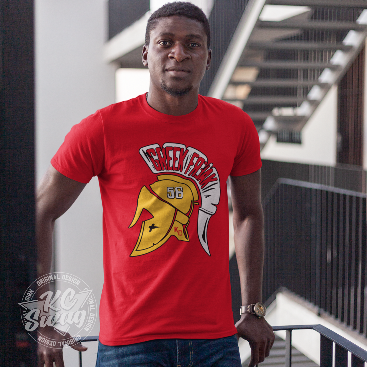 KC Swag - Kansas City Chiefs FEAR THE GREEK FREAK KARLAFTIS on red unisex t-shirt worn by male model leaning on railing of apartment patio
