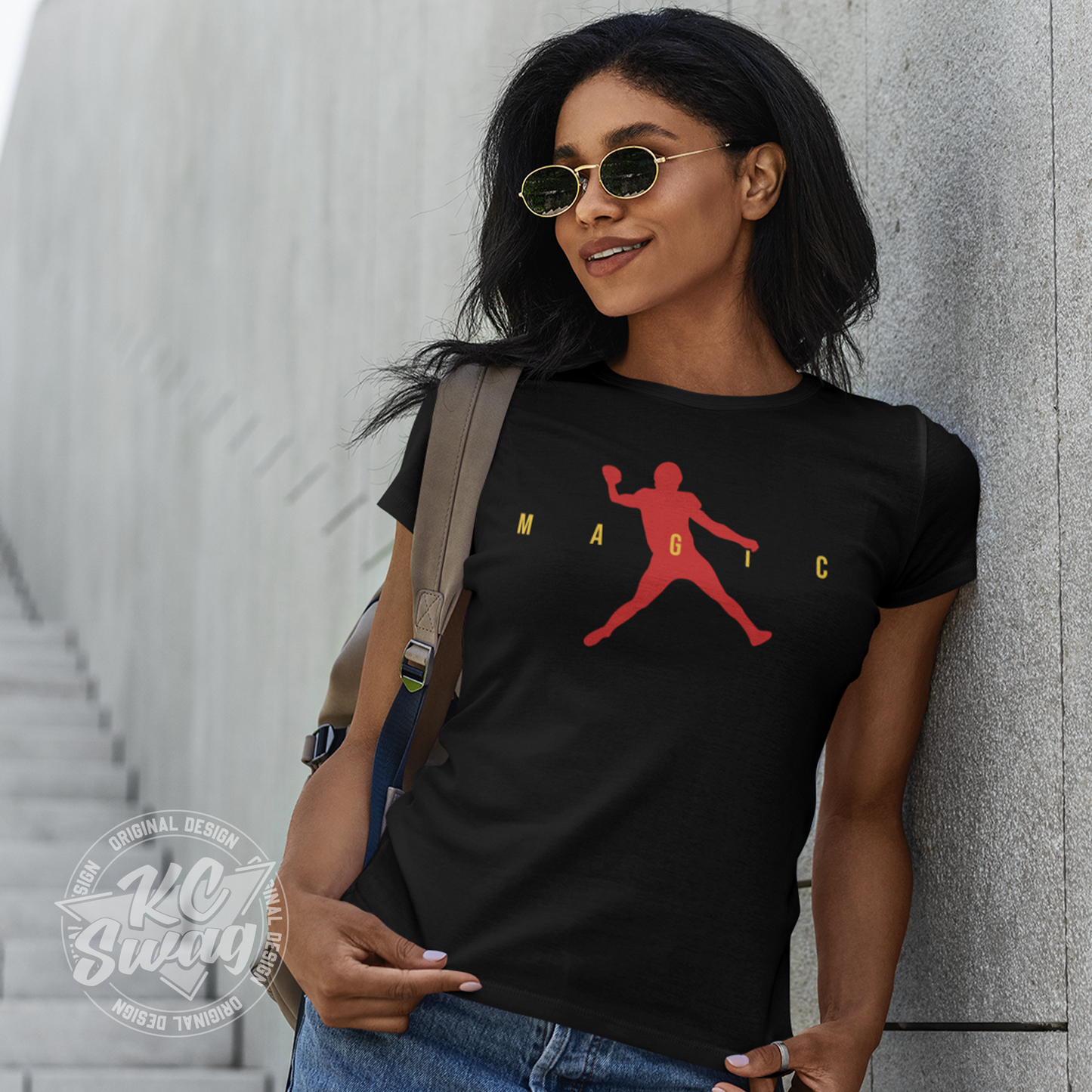 KC Swag - Kansas City Chiefs MAGIC AIR MAHOMES on black unisex t-shirt worn by female model leaning on concrete wall on giant staircase