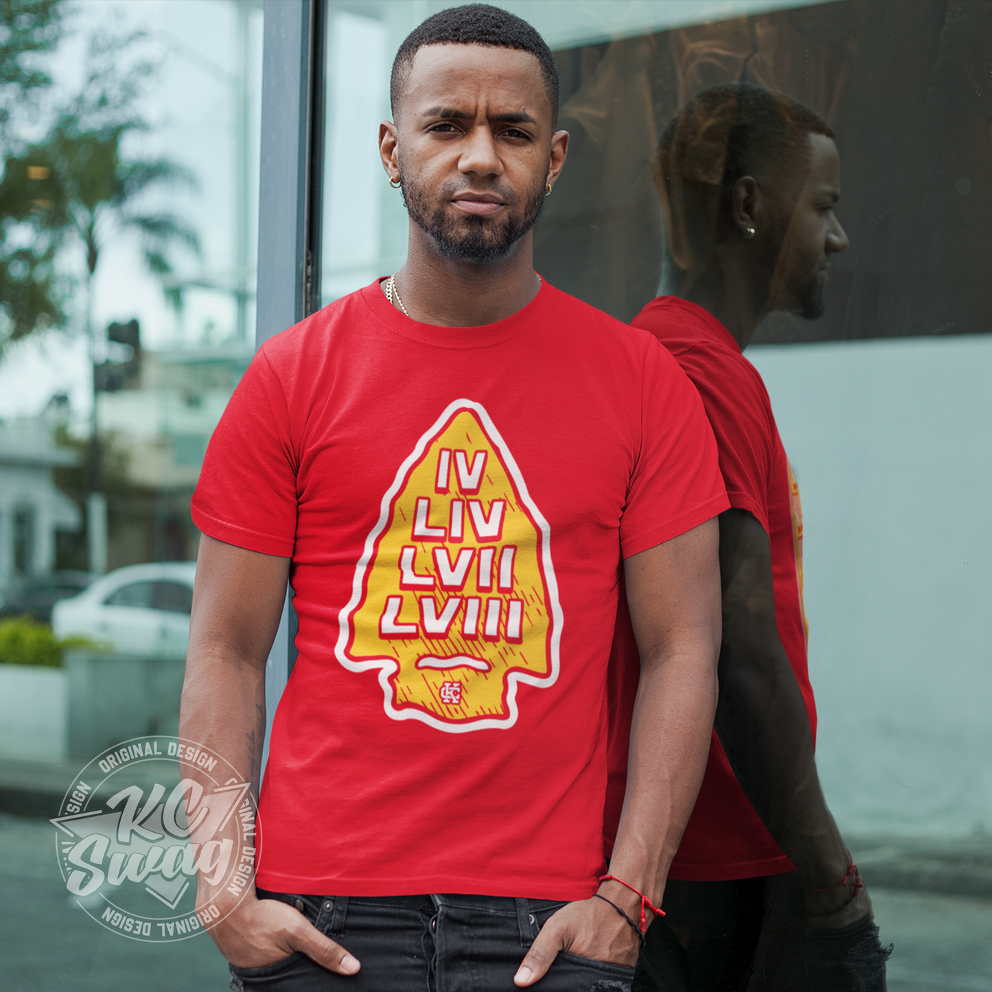 KC Swag - Kansas City Chiefs SUPER BOWL VICTORY ARROWHEAD on red unisex t-shirt worn by male model standing outside the windows of a retail storefront