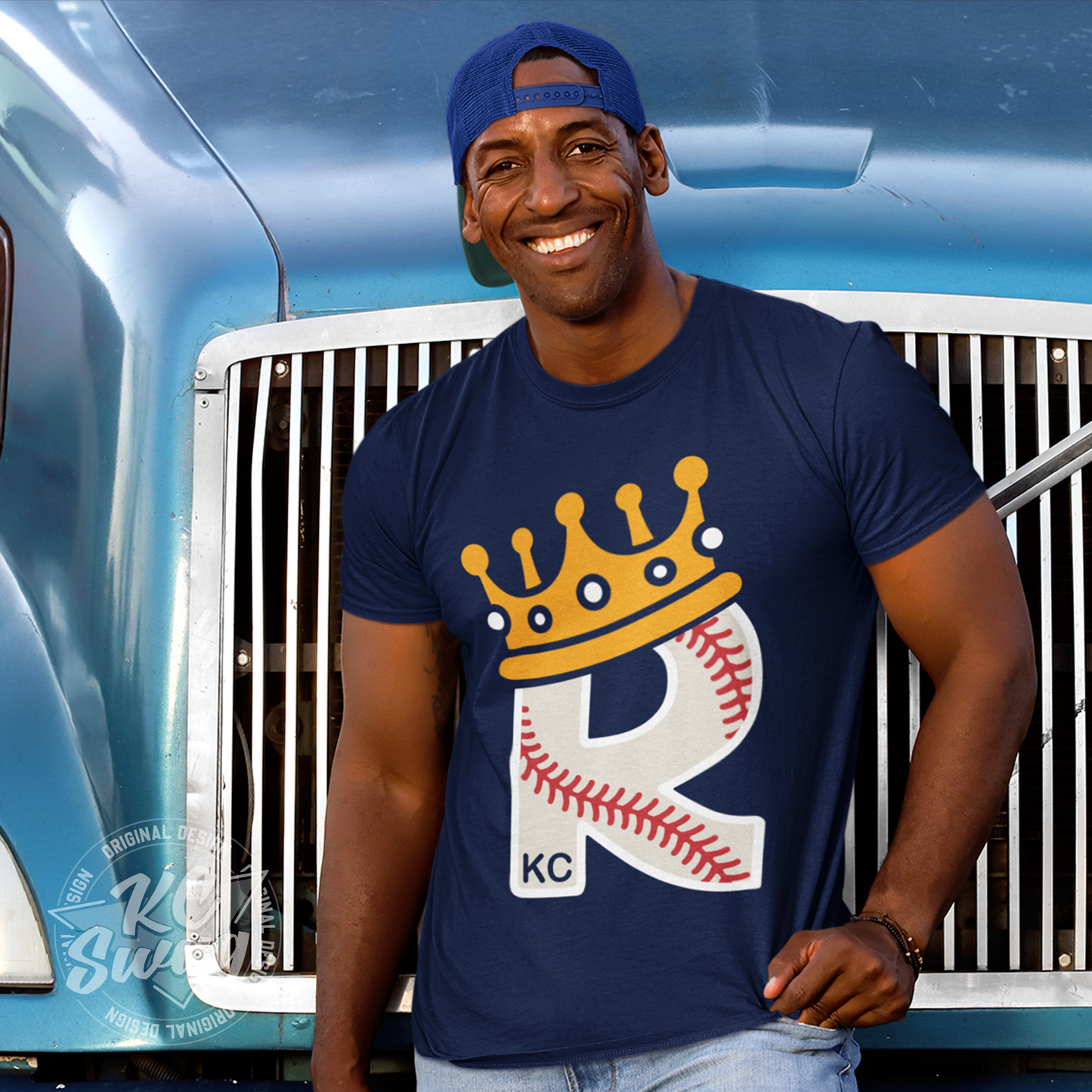 KC Swag - Kansas City Royals CROWN R-BALL KC on team navy blue unisex t-shirt worn by male model standing in front of a semi truck