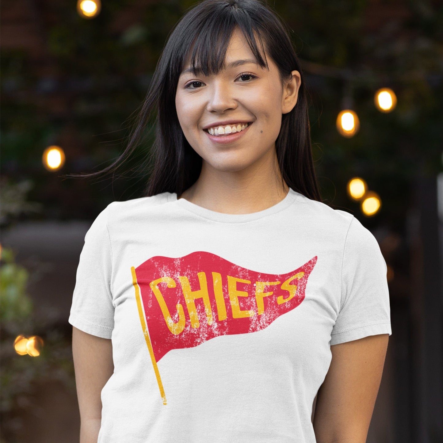 KC Swag Kansas City Chiefs red/yellow CHIEFS PENNANT on white t-shirt worn by female model in outdoor plaza
