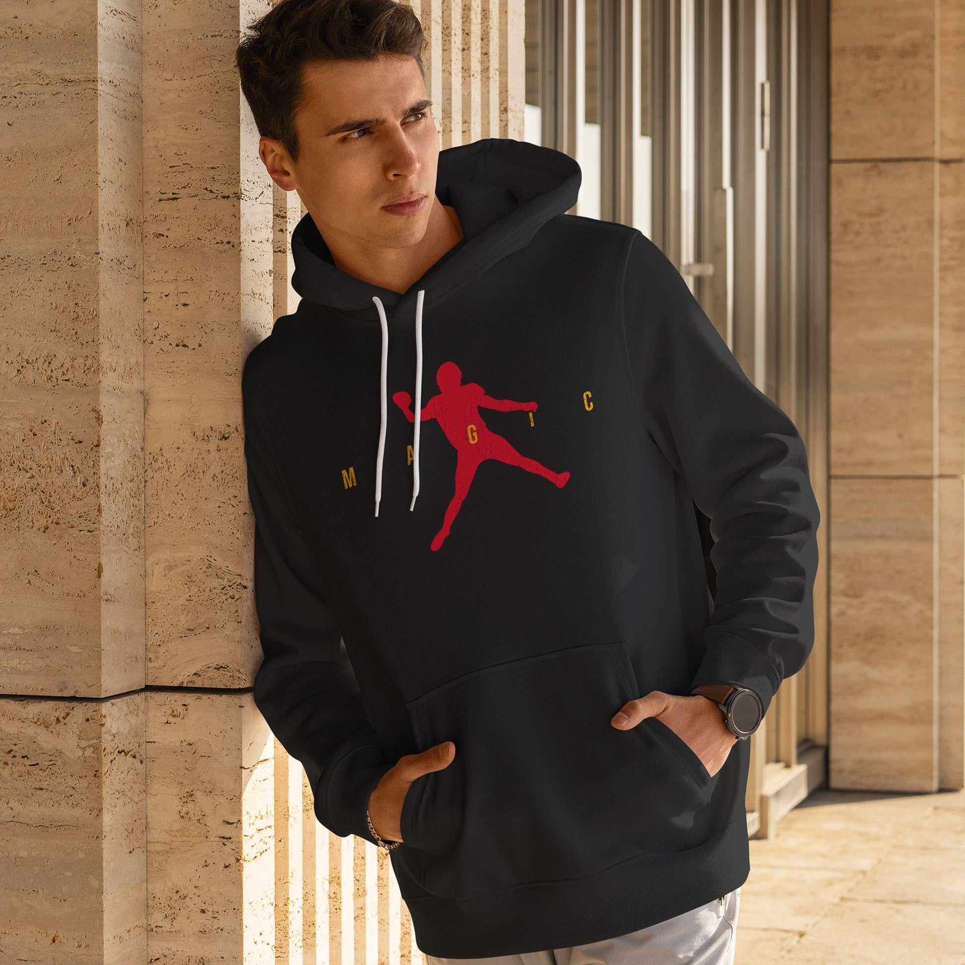 KC Swag | Kansas City Chiefs red/gold MAGIC AIR MAHOMIE on black sponge-fleece pullover hoodie worn by male model leaning on a stone building piilar