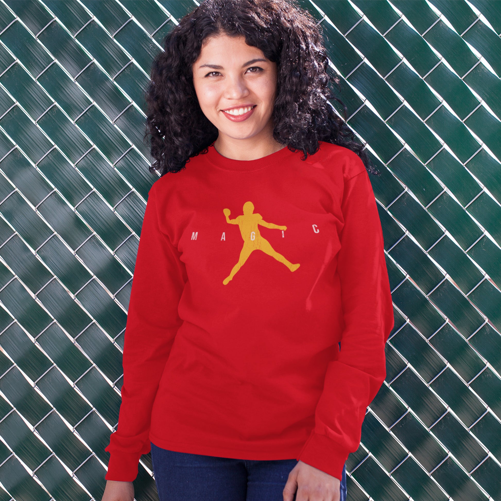KC Swag Kansas City Chiefs Distressed White & Gold Magic Air Mahomie on a Red Crewneck Sweatshirt worn by curly hair female model standing in front of a green tiled wall