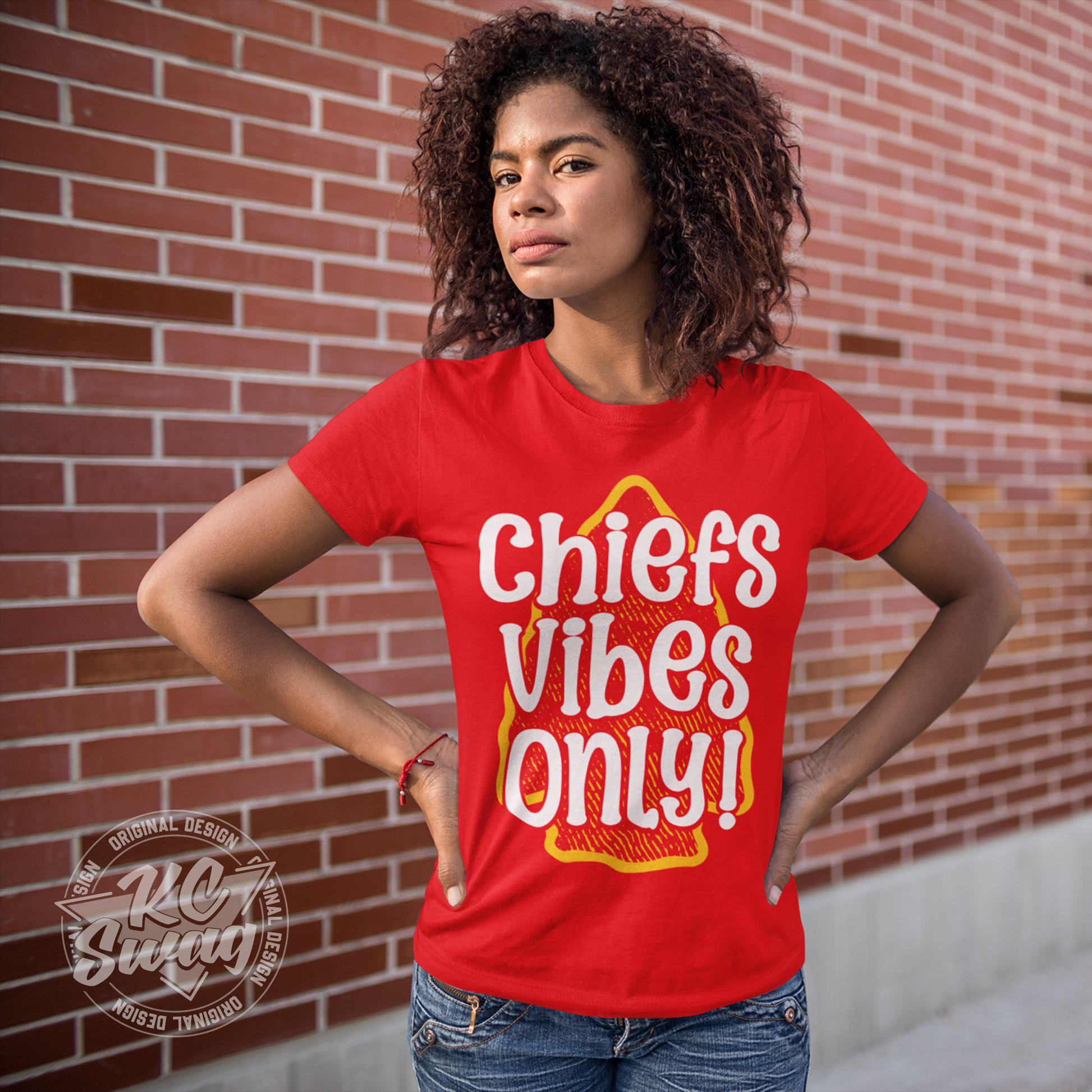 KC Swag - Kansas City Chiefs CHIEFS VIBES ONLY! on red unisex t-shirt worn by female model standing in front of a brick wall