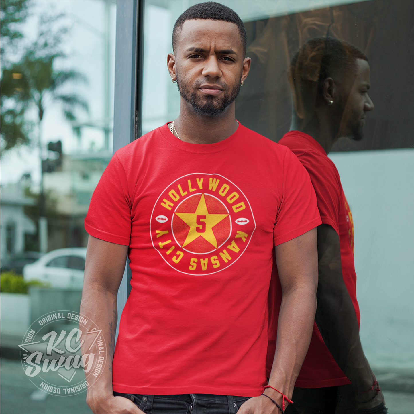 KC Swag - Kansas City Chiefs HOLLYWOOD BROWN STAR on red unisex t-shirt worn by male model standing outside windows of retail storefront