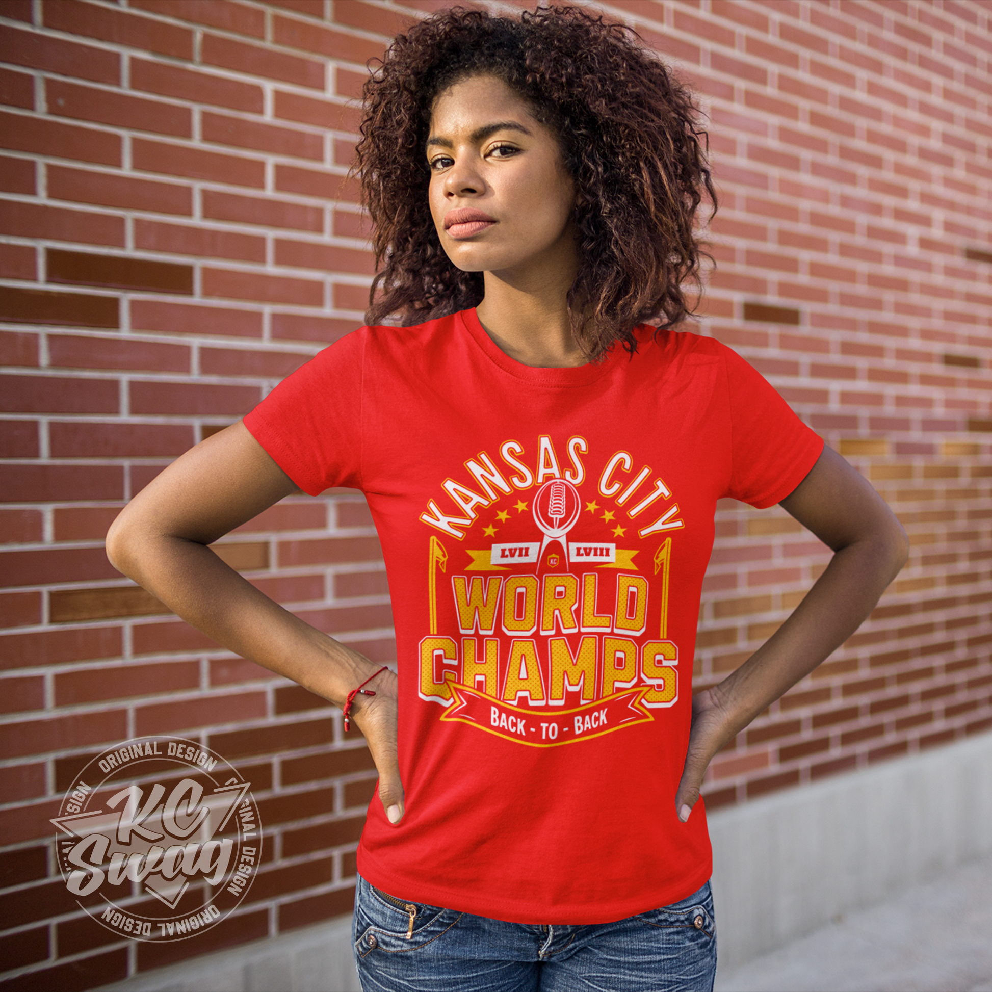 KC Swag - Kansas City Chiefs KANSAS CITY WORLD CHAMPS BACK TO BACL LVII LVIIIon red unisex t-shirt worn by female model standing in front of a brick wall