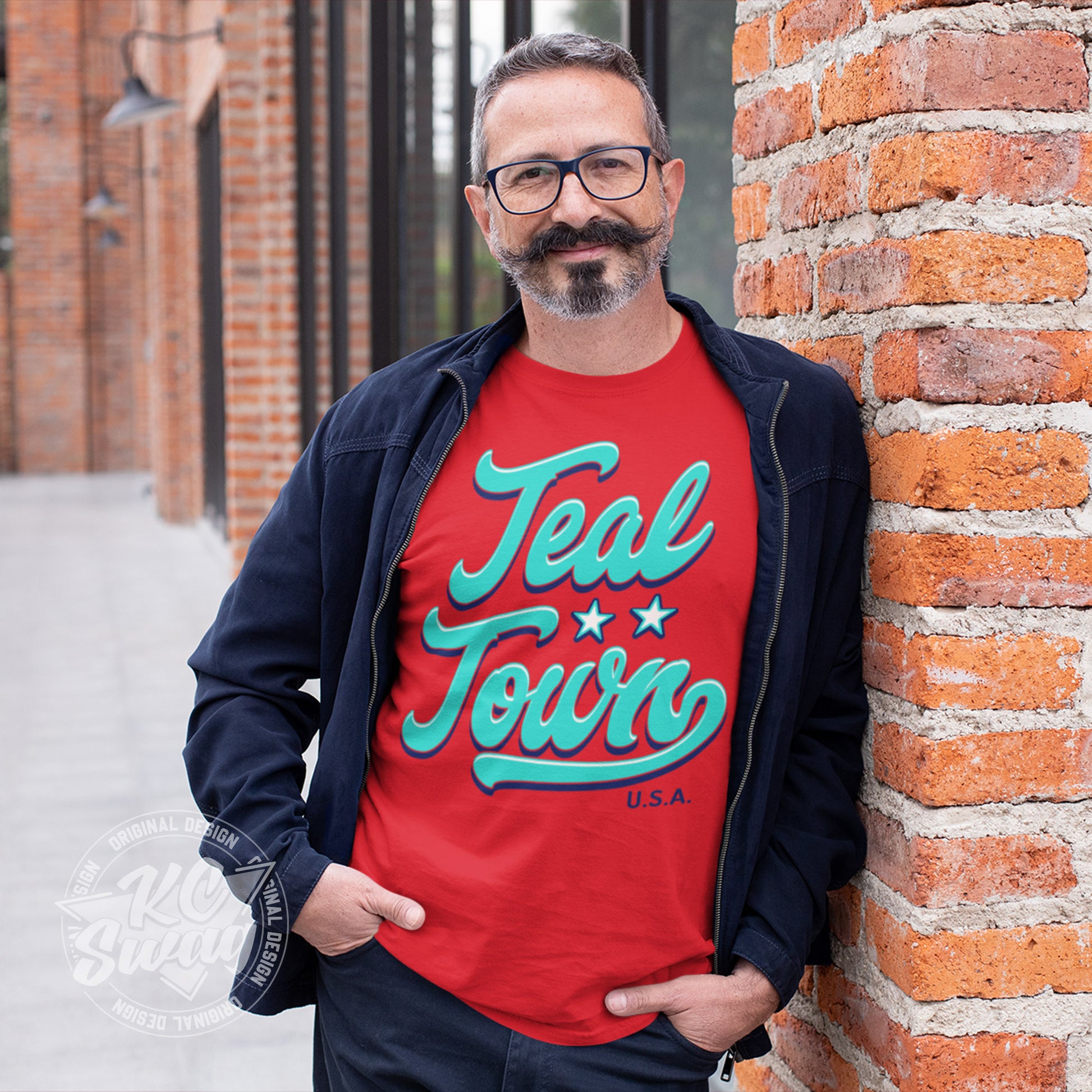 KC Swag - Kansas City Current, Teal Town USA design on red unisex t-shirt worn by male model with an old=timey mustache under an open denim jacket