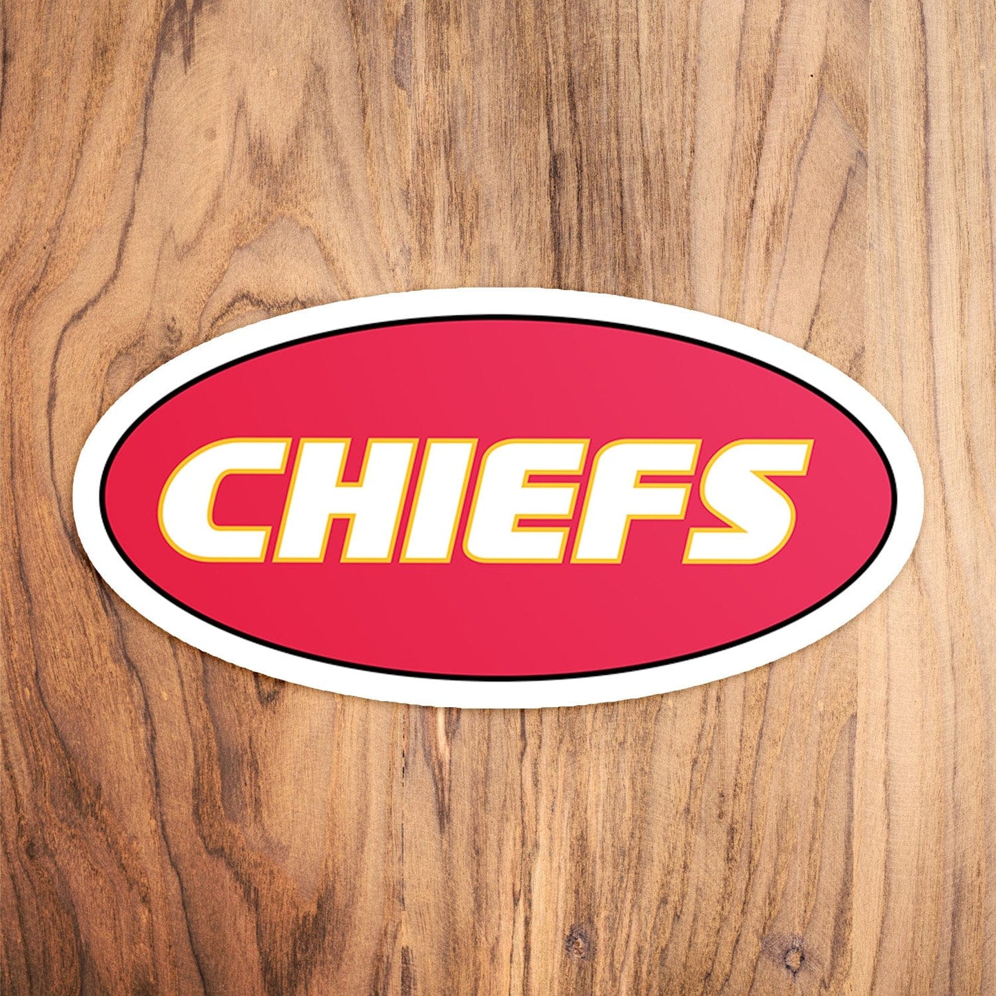 KC Swag Kansas City Chiefs red, yellow CHIEFS CLASSIC OVAL vinyl die cut decal sticker on wood table