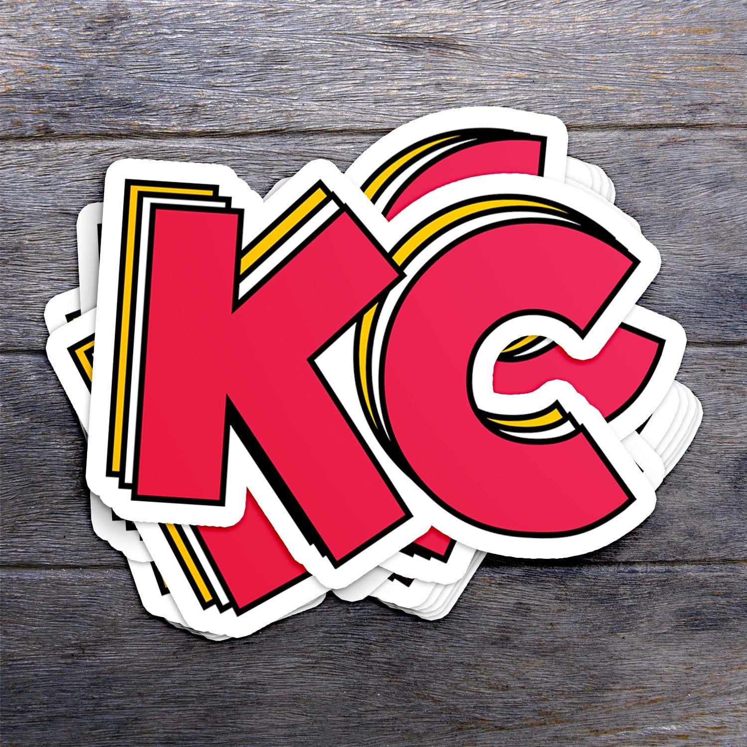 KC Swag Kansas City Chiefs red, yellow STACKED RED KC vinyl die cut decal sticker stack on dark wood table