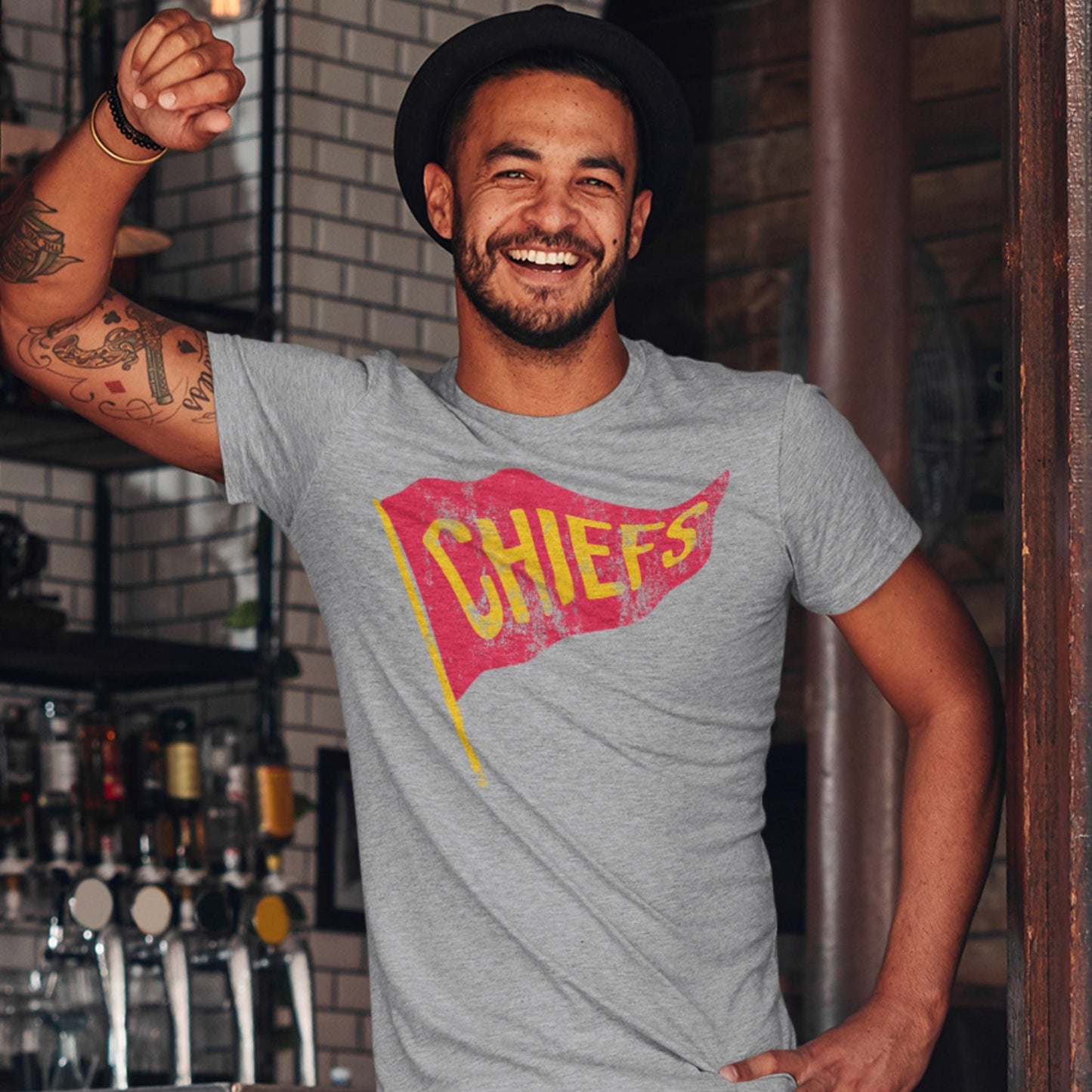 KC Swag Kansas City Chiefs red/yellow CHIEFS PENNANT on athletic heather grey t-shirt worn by male model in pub