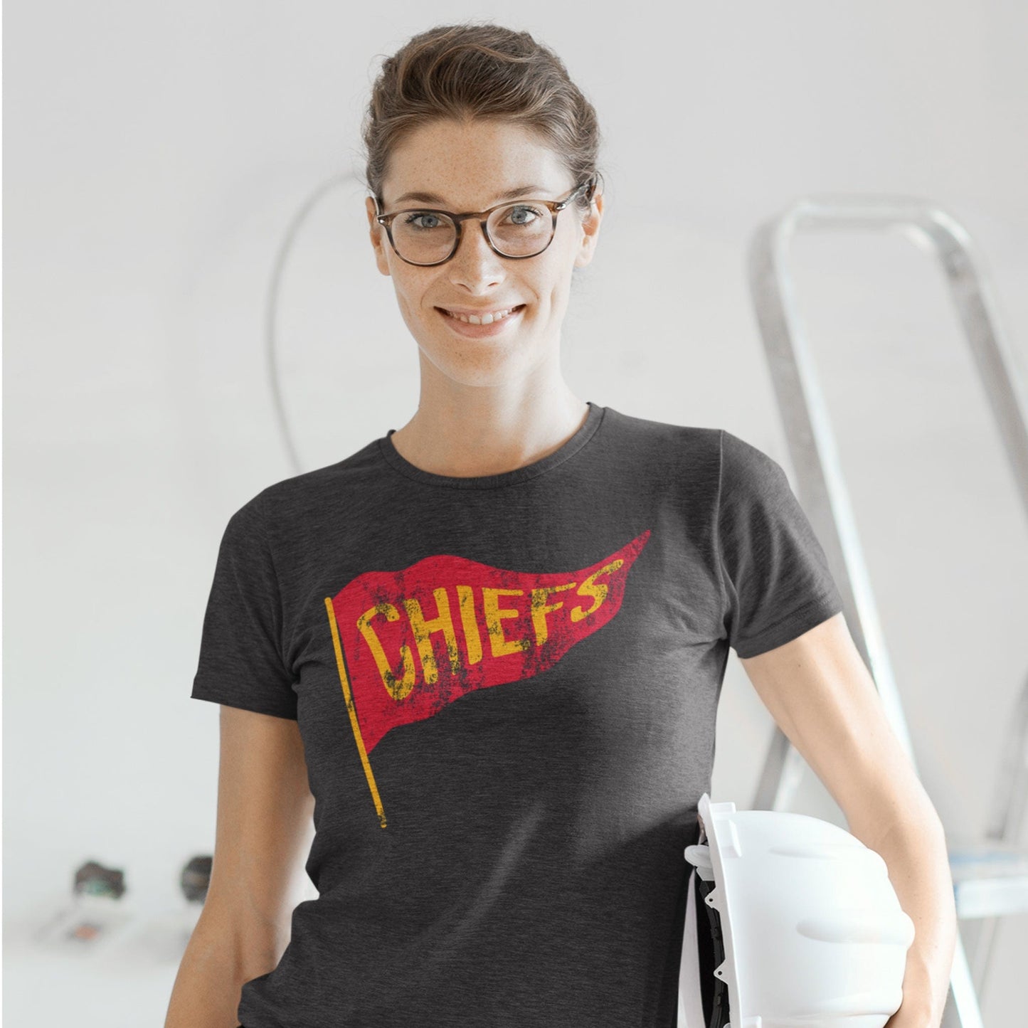 KC Swag Kansas City Chiefs red/yellow CHIEFS PENNANT on dark heather grey t-shirt worn by female model on construction site