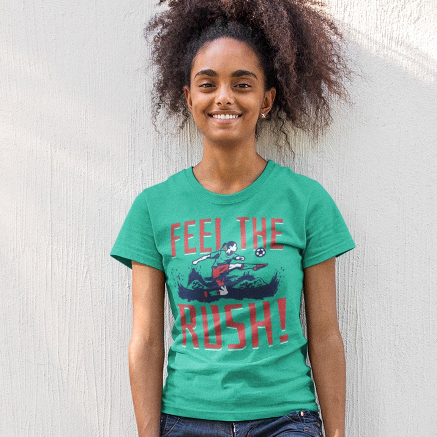 KC Swag Kansas City Current FEEL THE RUSH on teal unisex t-shirt worn by female model leaning against white painted wall