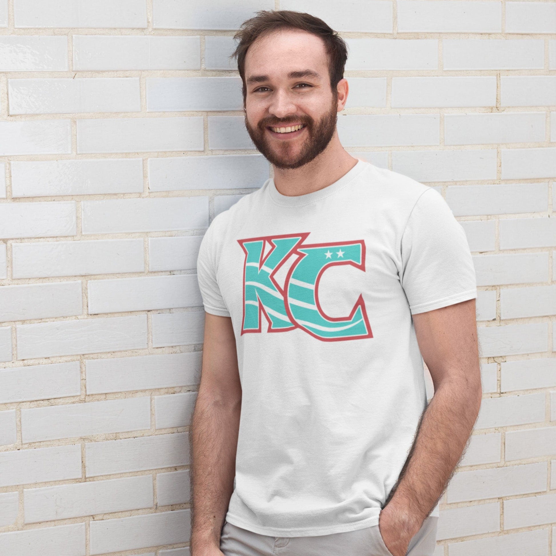 KC Swag Kansas City Current CURRENT KC on white unisex t-shirt worn by male model leaning on white brick wall