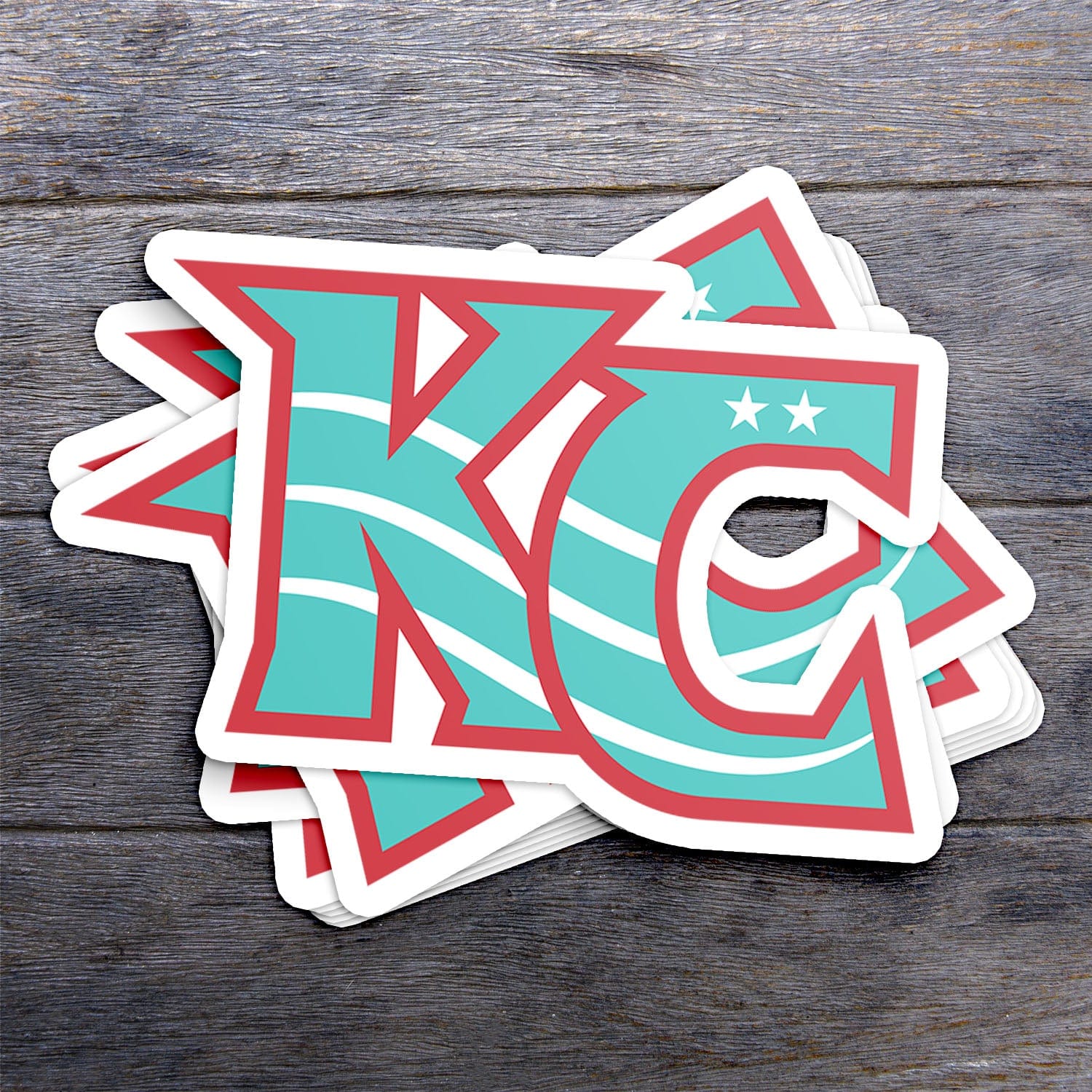 KC Swag Kansas City Current CURRENT KC die-cut sticker decal made from waterproof vinyl stack on dark wood table