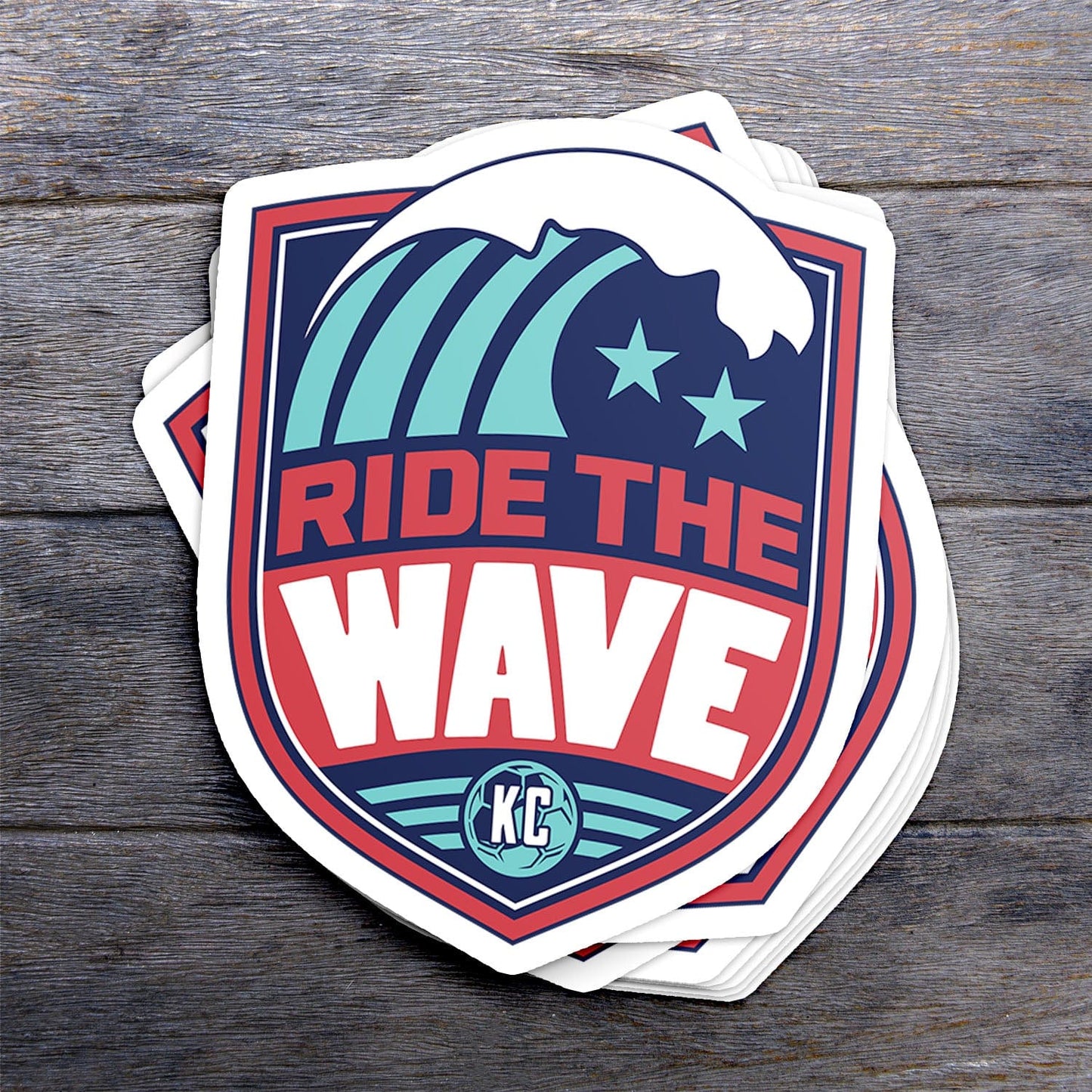 KC Swag Kansas City Current RIDE THE WAVE die-cut sticker decal made from waterproof vinyl stack on dark wood table