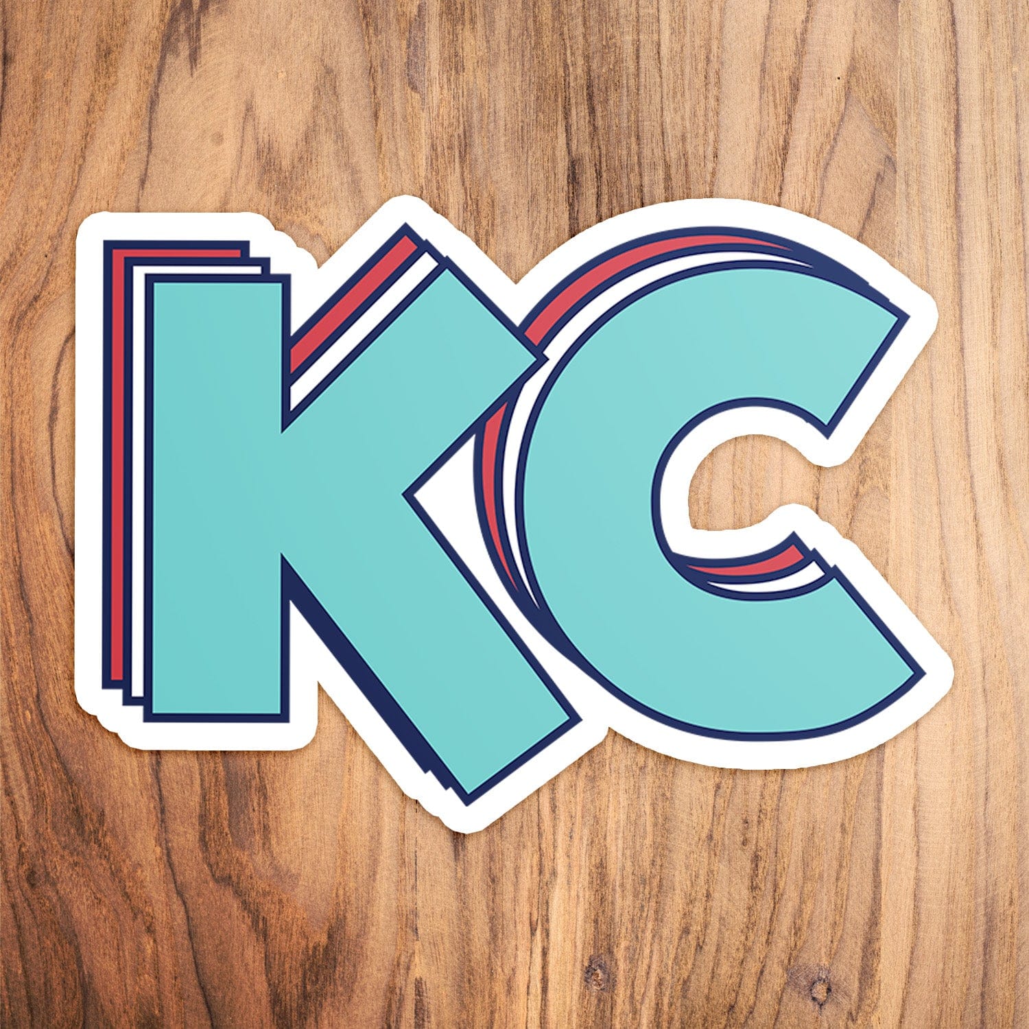 KC Swag Kansas City Current STACKED TEAL KC die-cut sticker decal made from waterproof vinyl on wood table