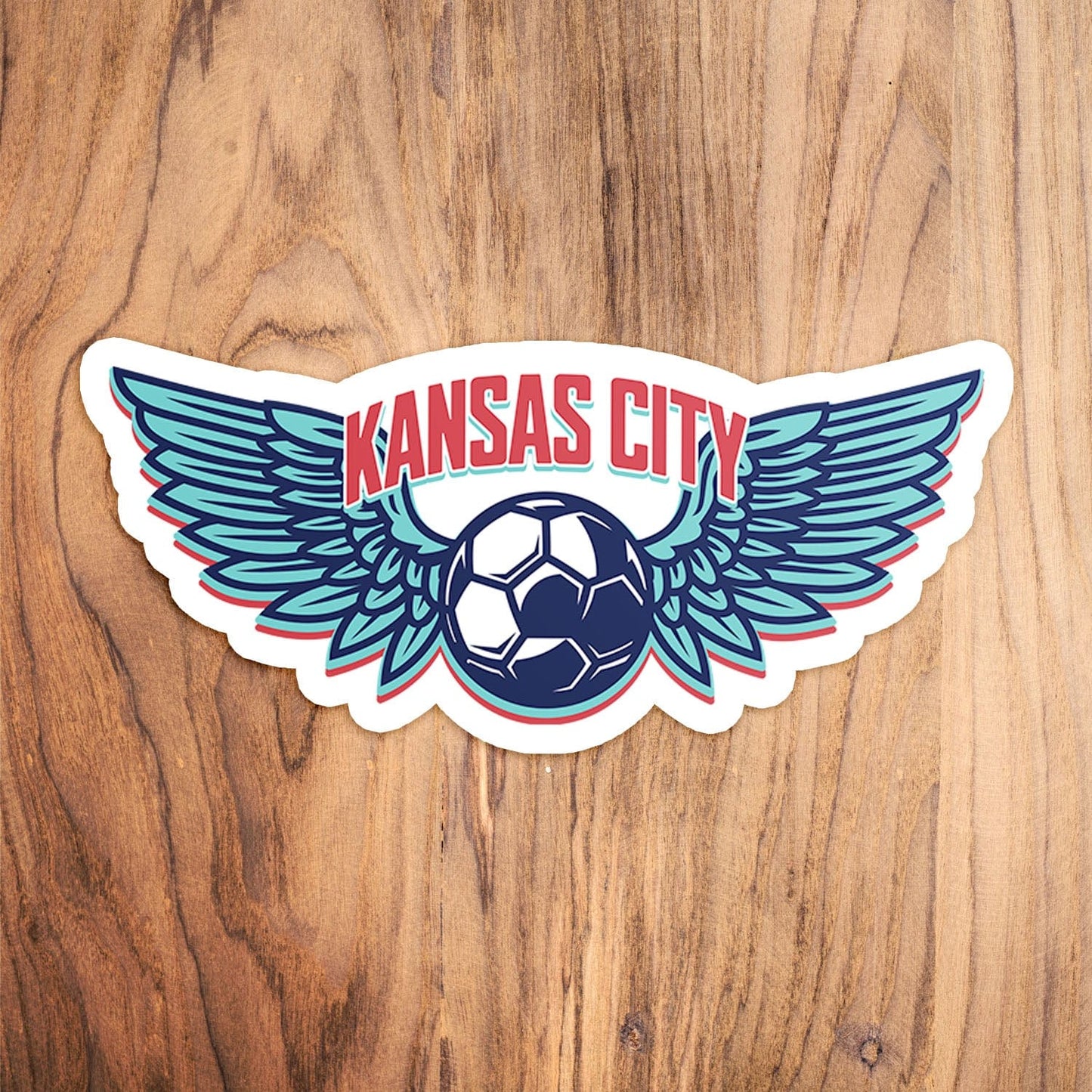 KC Swag Kansas City Current KC WING BALL die-cut sticker decal made from waterproof vinyl on wood table