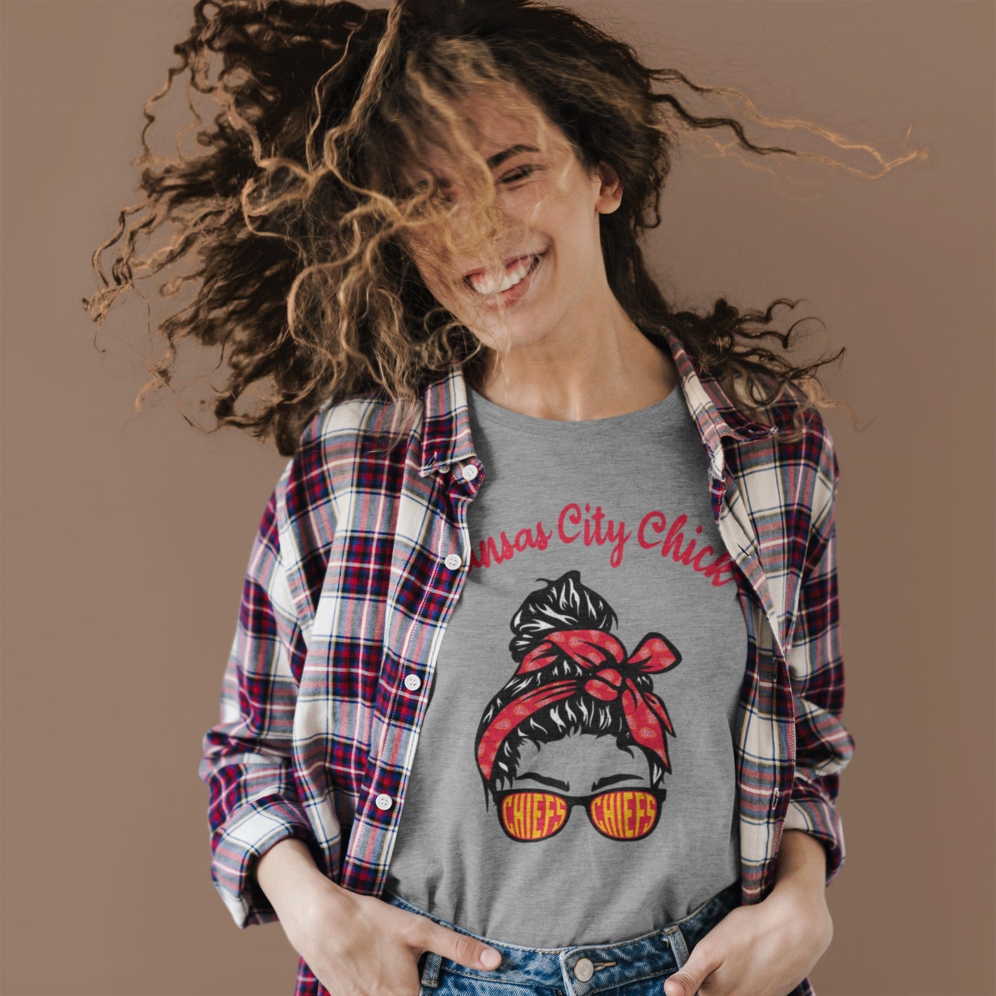 KC Swag Kansas City Chiefs red/black/yellow KANSAS CITY CHICK with girl in bandana and CHIEFS sunglasses graphic on athletic heather grey t-shirt worn by female model tossing her hair around