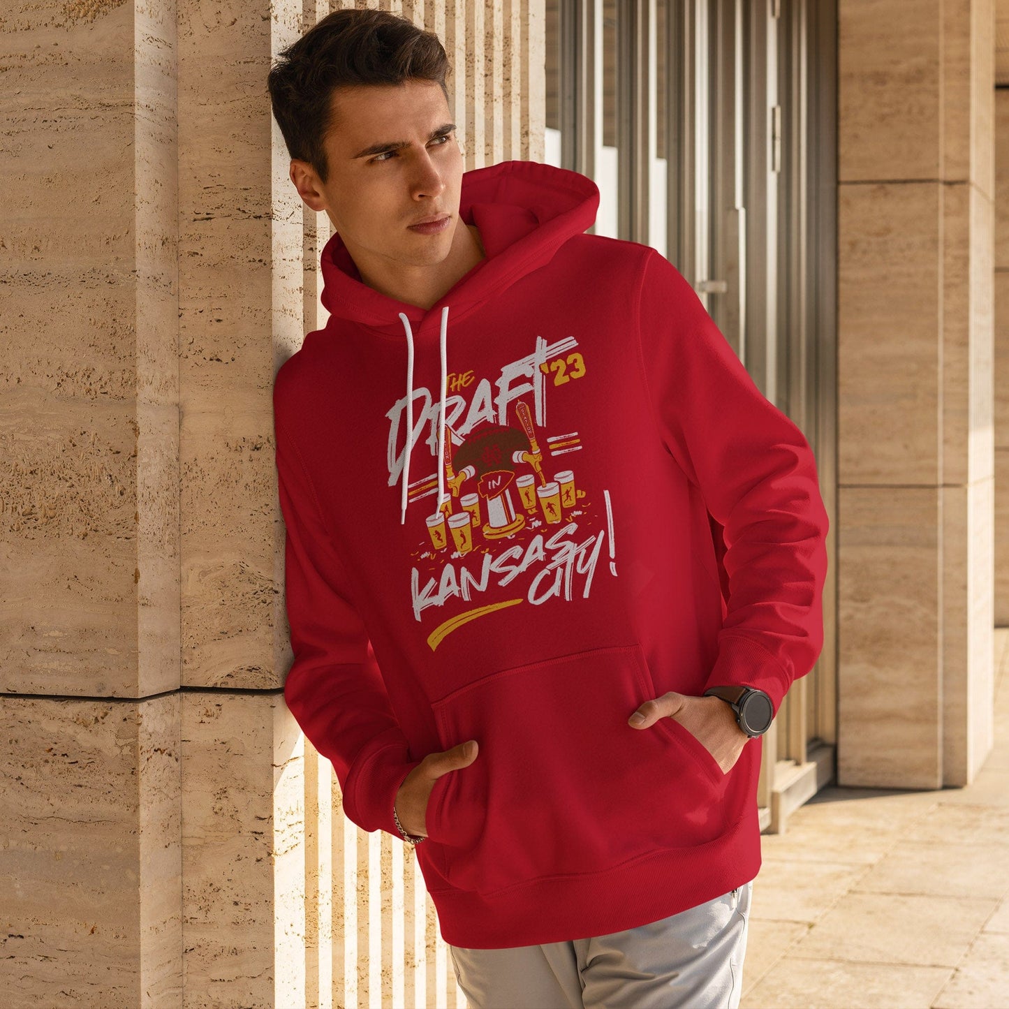 KC Swag Kanssas City Chiefs DRAFTIN' IN KC on red pullover fleece hoodie worn by male model leaning against stone building
