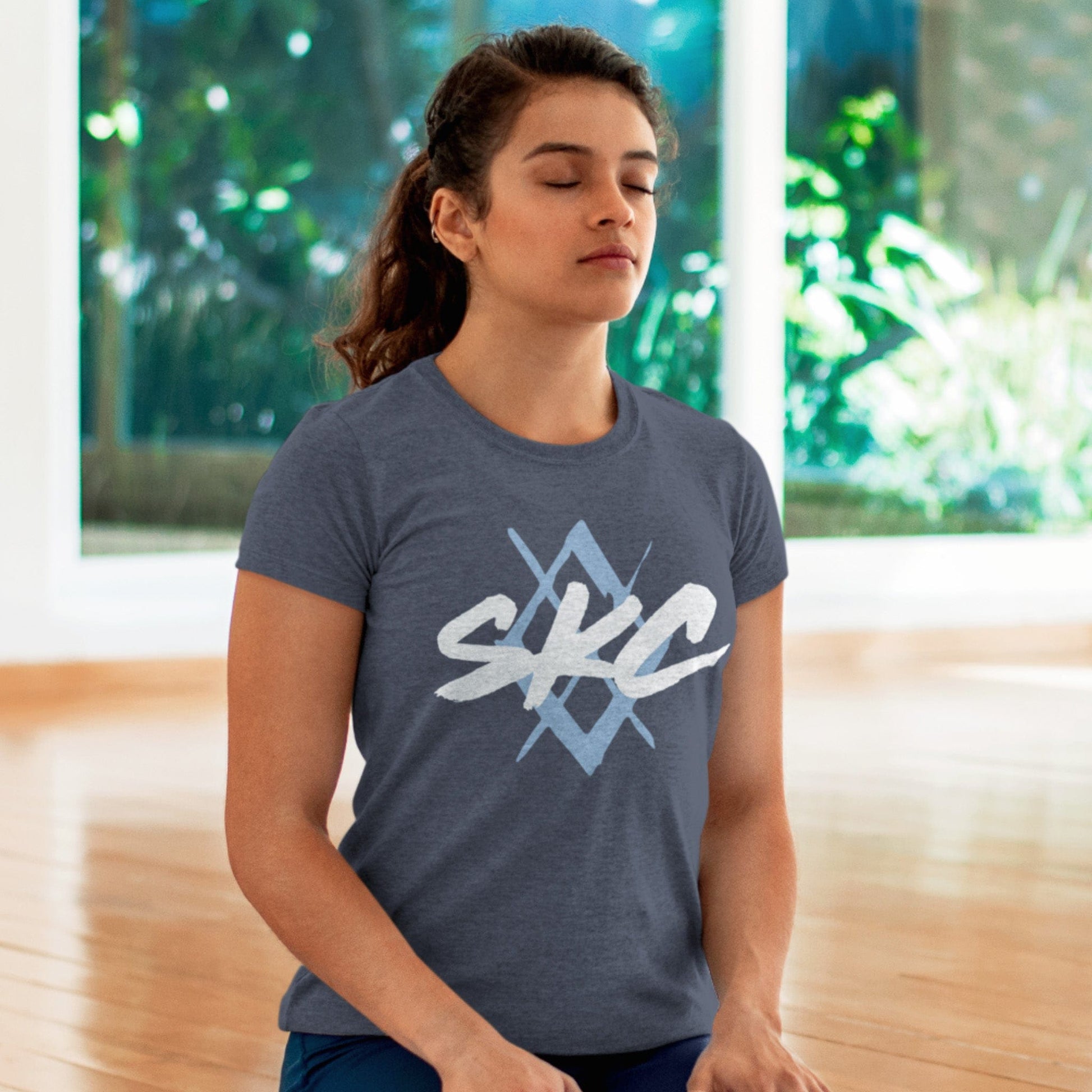 KC Swag Sporting Kansas City PAINTED SKC DIAMOND on heather slate unisex t-shirt worn by female model kneeling in meditation