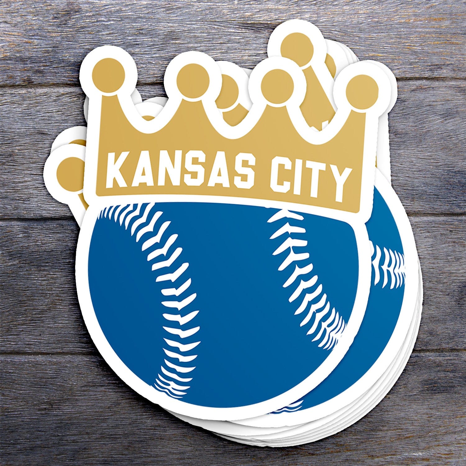 KC Swag Kansas City Royals blue, gold, BASEBALL CROWN vinyl die cut decal sticker stack on dark wood table