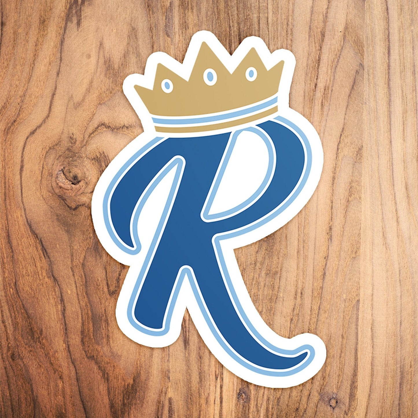 KC Swag Kansas City Royals blue, gold, powder blue CROWN R vinyl die cut decal sticker on wood table