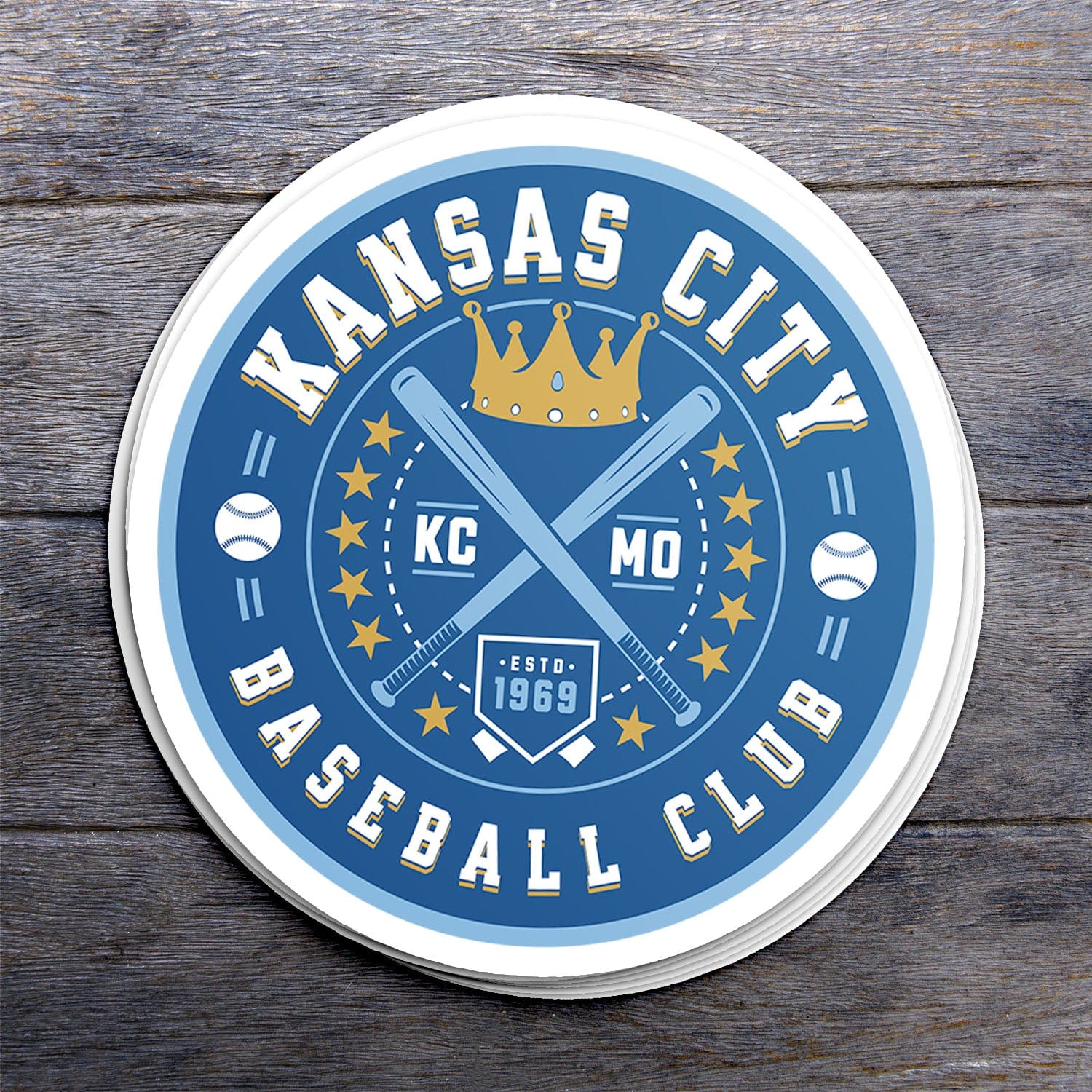 KC Swag Kansas City Royals blue, gold, powder blue KC BASEBALL CLUB vinyl die cut decal sticker stack on dark wood table