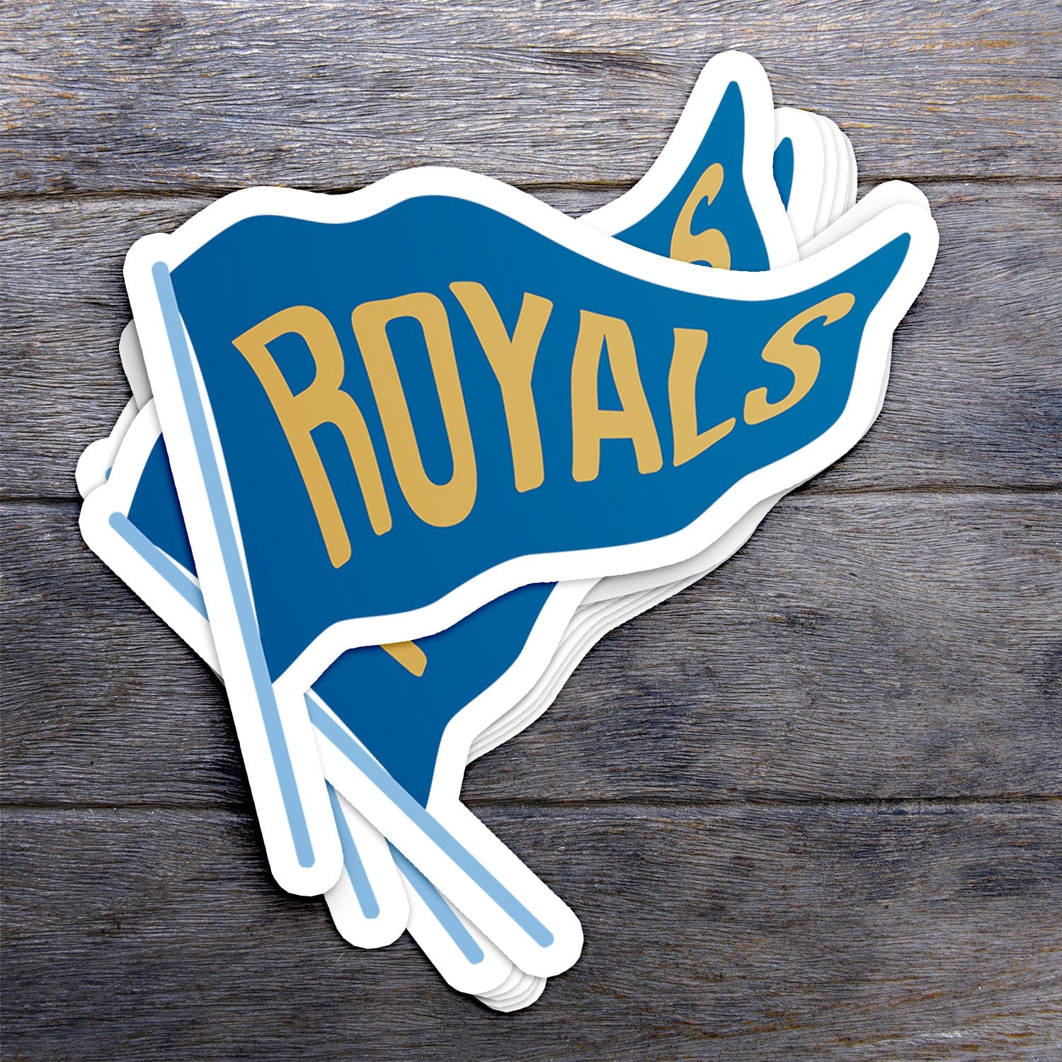 KC Swag Kansas City Royals blue, gold, powder Royals Pennant vinyl die cut decal sticker stack on dark wood table