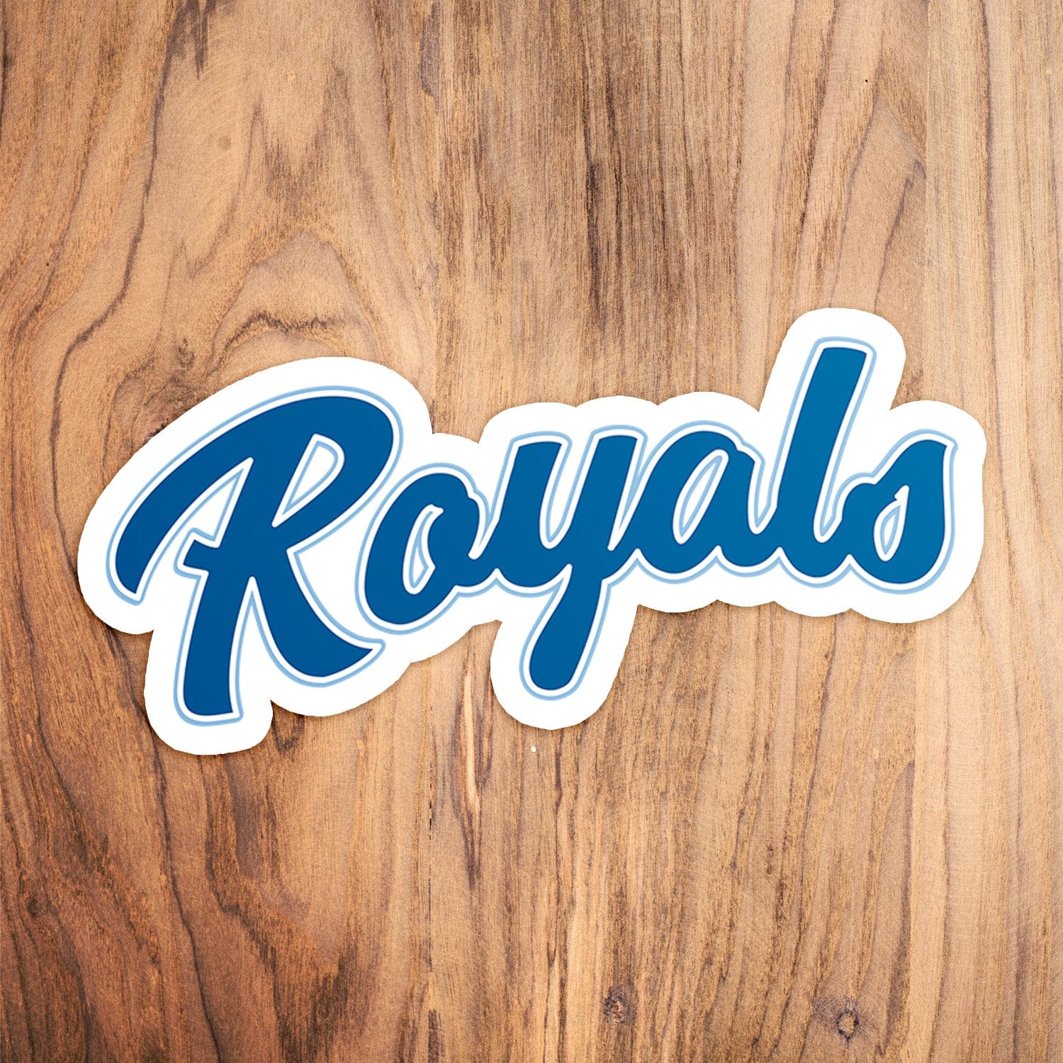 KC Swag Kansas City Royals blue, powder Royals Scrip vinyl die cut decal sticker on wood table