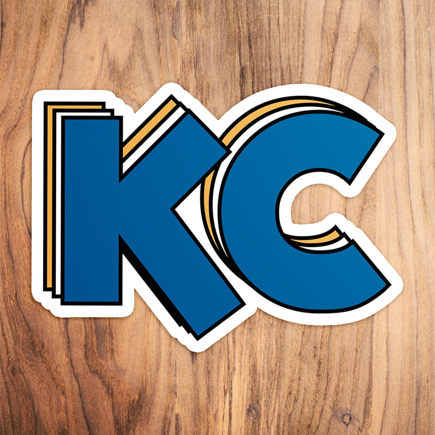 KC Swag Kansas City Royals blue, gold, white Stacked Blue KC vinyl die cut decal sticker on wood table