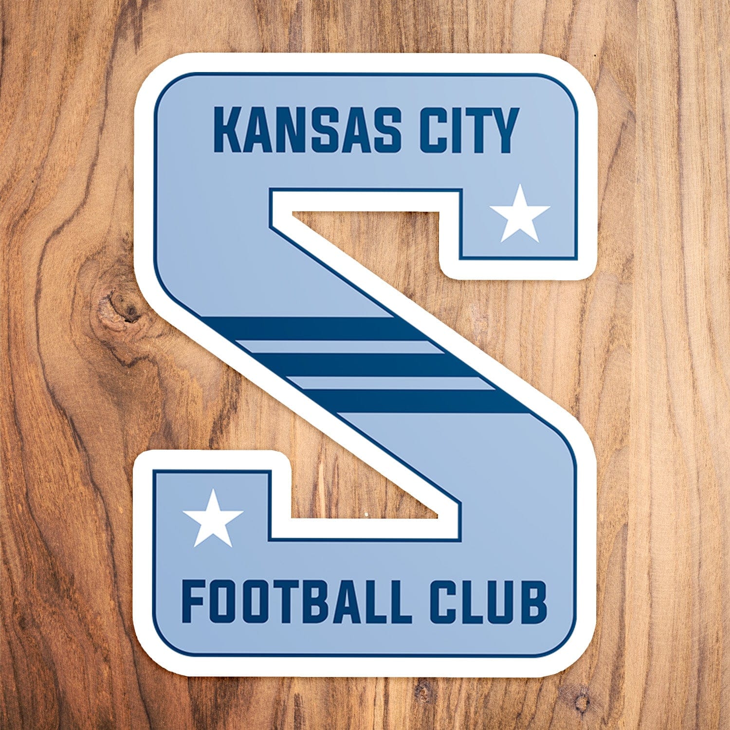 KC Swag Sporting Kansas City powder, navy, white KC Football Club S vinyl die cut decal sticker on wood table