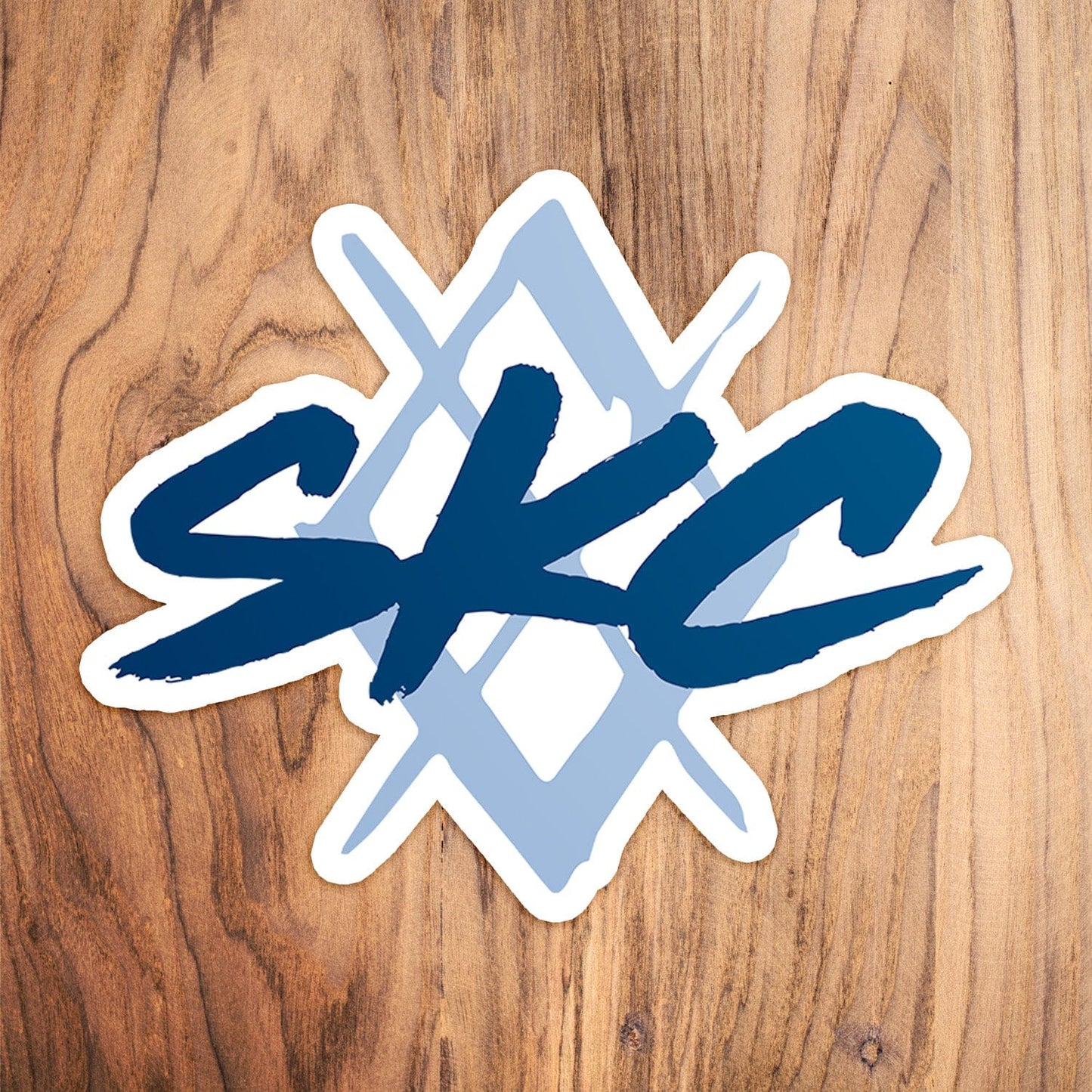 KC Swag Sporting Kansas City powder, and navy Painted Diamond vinyl die cut decal sticker on wood table