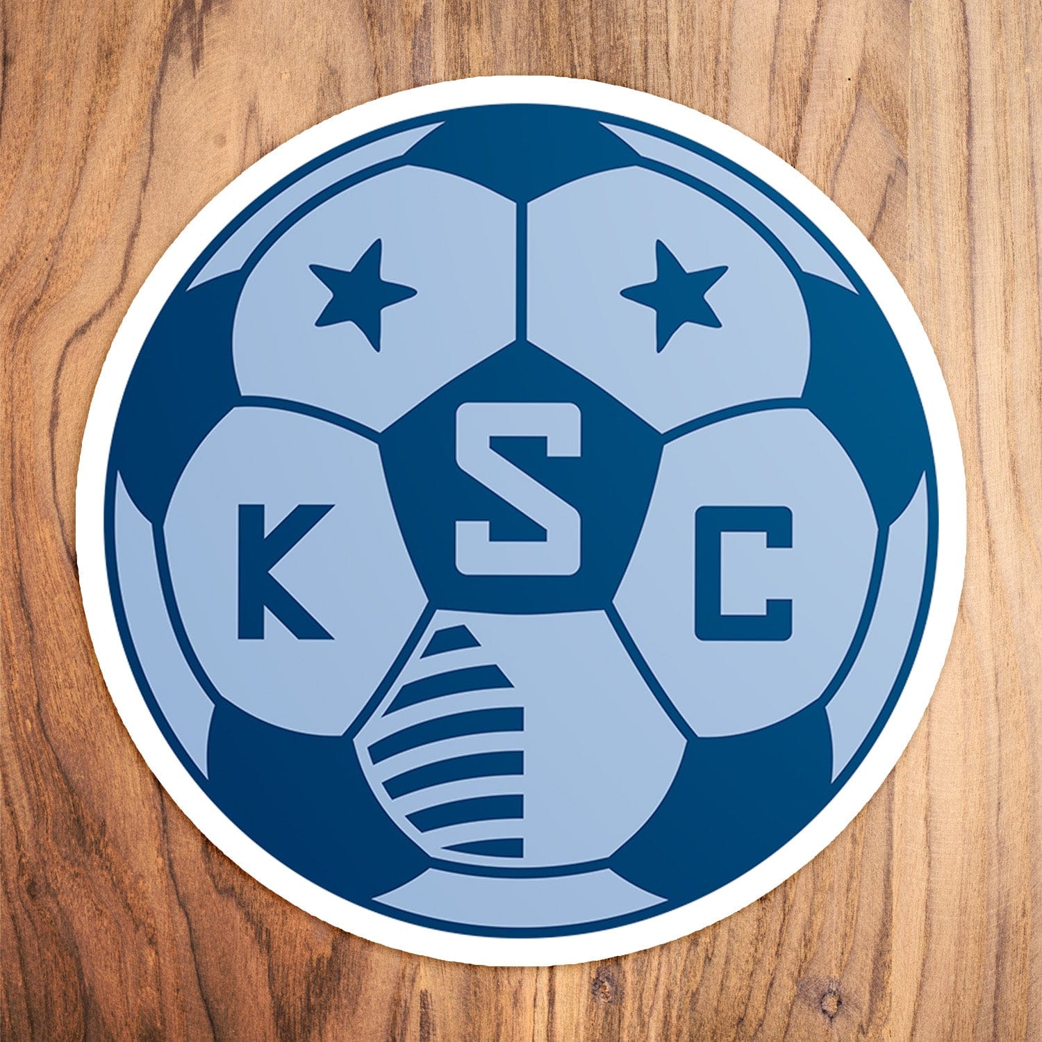 KC Swag Sporting Kansas City powder, navy, SKC Soccer Ball vinyl die cut decal sticker on wood table