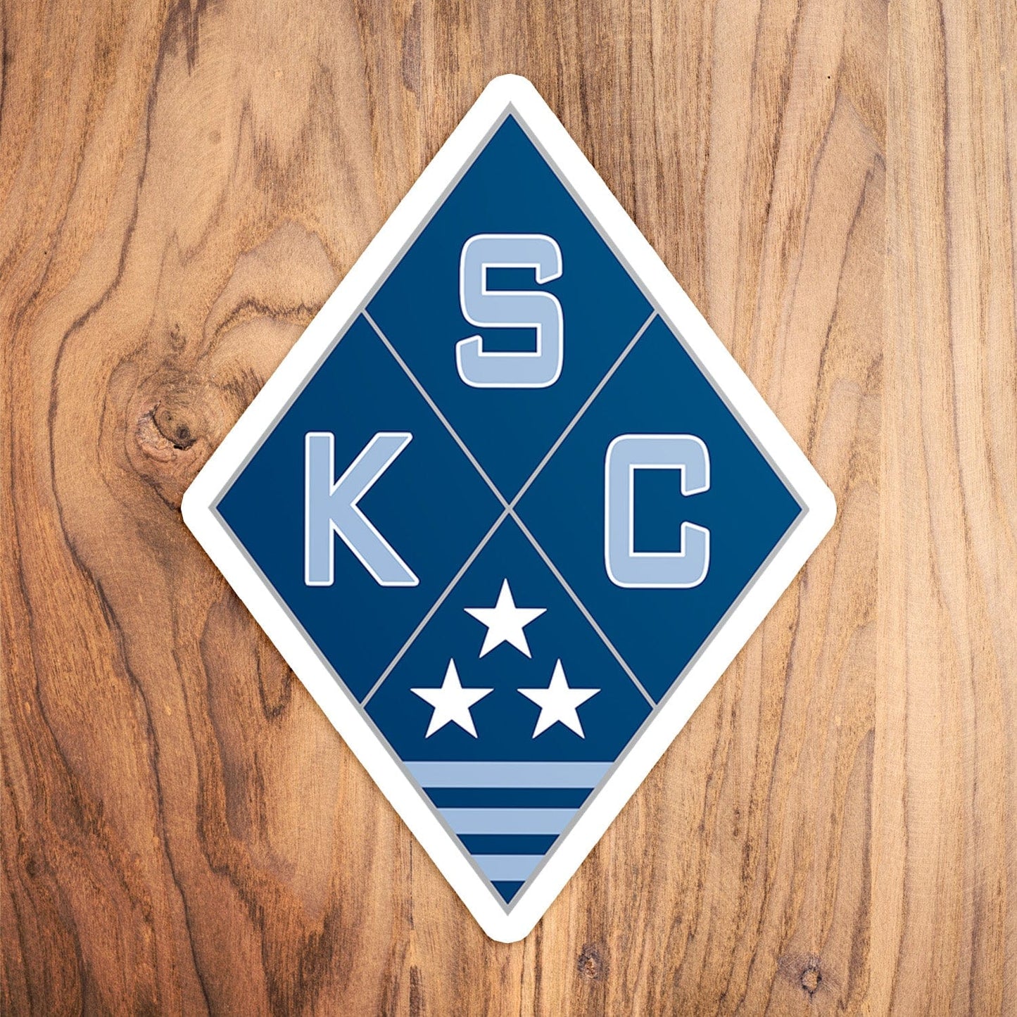 KC Swag Sporting Kansas City powder, navy, silver SKC Diamond vinyl die cut decal sticker on wood table