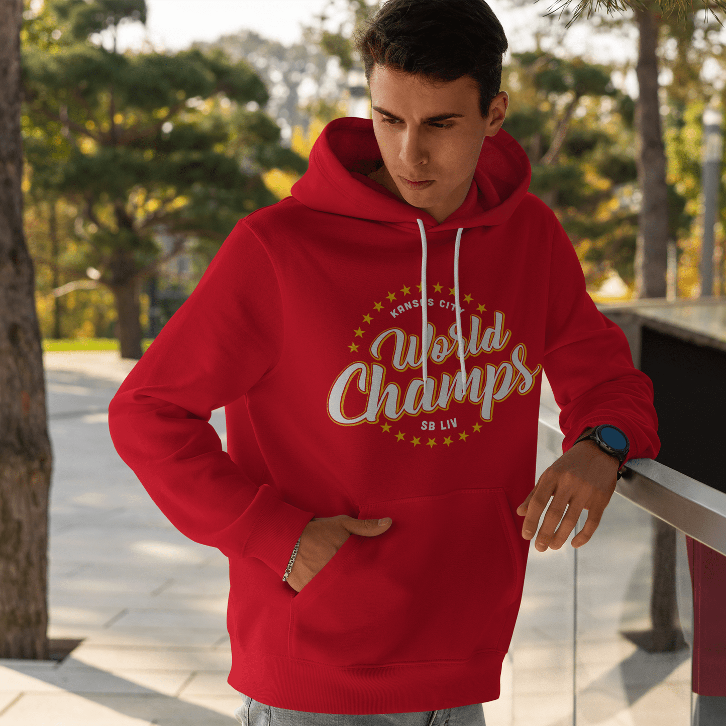 KC Swag Kansas City WORLD CHAMPS SBLIV on red fleece pullover hoodie worn by male model standing in outdoor plaza